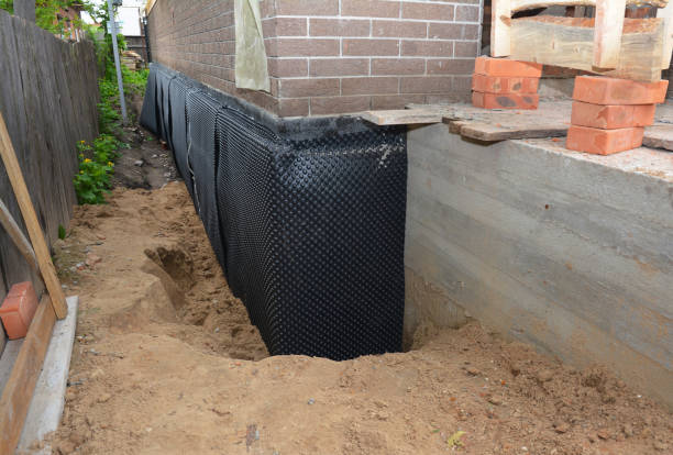 Happy homeowners after waterproofing job in Fall River